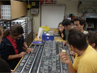 Researchers engaged in discussion aboard the research vessel, JOIDES Resolution, during a survey of the East Pacific Ridge